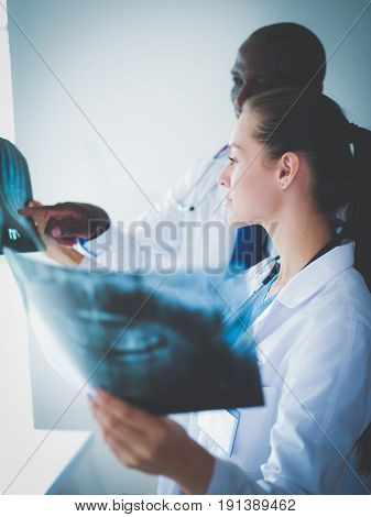 Doctors analyzing an x-ray in a meting. Doctors
