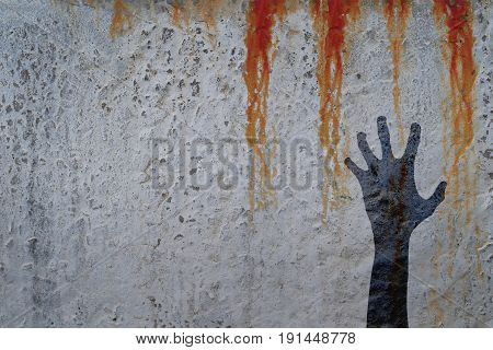 Zombie hand silhouette in shadow on concrete wall and blood background with copy space for text or image. Zombie theeme with corpse hands on cemetery. Halloween theme.