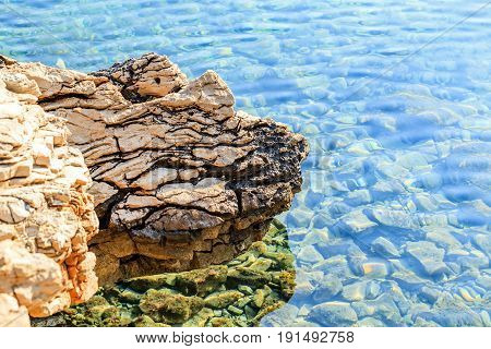 Landscape photo of rocky adriatic shore and crystal clear water