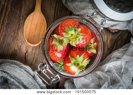 Strawberry In Jar On Wooden Background.