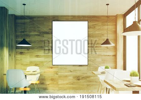 Front view of a lilght wooden cafe interior with square tables white chairs standing along a panoramic window and a framed vertical poster on a wall. 3d rendering mock up toned image