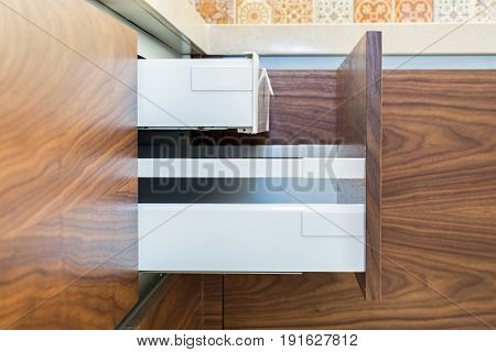 Drawers of design kitchen. Two drawers in one. The upper is designed for storing kitchen appliances - knives, forks, spoons, foil, etc. European furniture, design, technologies.