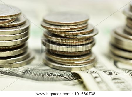 Close up of money - coins stacked on bills