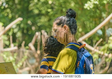 GUAYAQUIL, ECUADOR, MAY - 2016 - Mother and son at historic park zoo located at samborondon neighborhood Guayaquil Ecuador