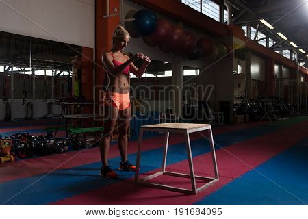 Woman Working Out With Fit Box At Gym