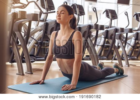 Young female training in gym healthy lifestyle exercise on yoga mat