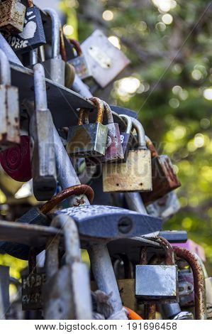 close-up of many different closed lovelocks at the bridge