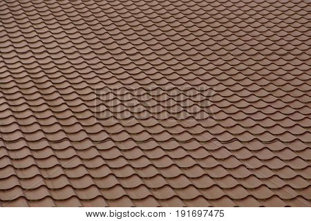 Brown roof tile on the roof of a dwelling house