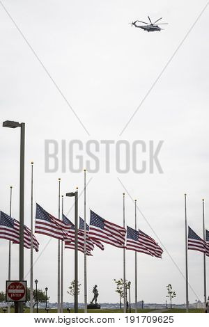 US Marine Corps Ironhorse 01 H-461 helicopter flies above the American Flag Plaza and Liberation Monument in Liberty State Park on the Hudson River, Fleet Week New York, JERSEY CITY NJ MAY 24 2017.
