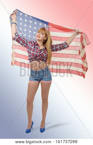 a sexy pin up girl holding an American flag.