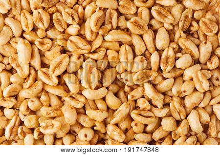Puffed honey air rice wheat closeup background. Cereals texture.