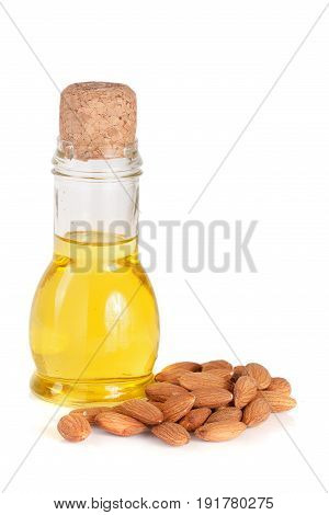 Bottle of almond oil and almonds isolated on white background.