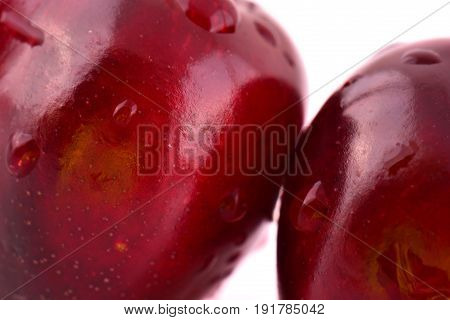 Sweet red cherry with water drops macro photo on white background