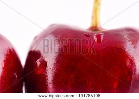 Sweet red cherry with water drops macro photo on white background