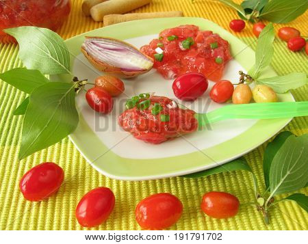 Homemade chutney from cornelian cherries, oniens and herbs