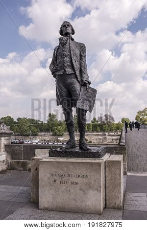 ParisFrance- April 29 2017: Monument to Jefferson at Bridge Leopold Sedar Senghor. Citizens go on their own business