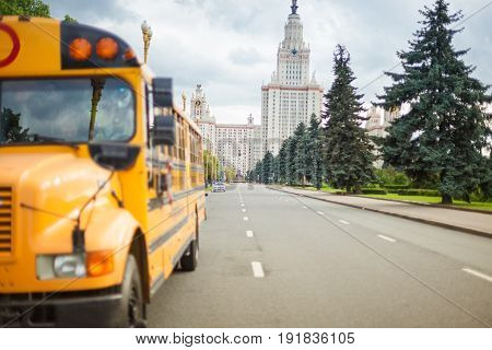 American yellow school and student bus in Moscow against the background of university MSU