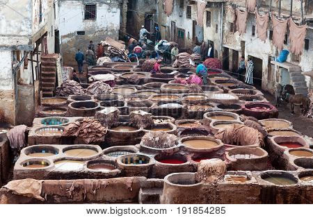Men Working Hard In The Tannery Souk In Fez, Morocco