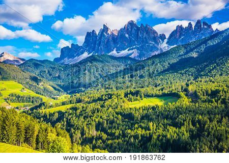 Warm autumn in the Dolomites, the Val de Funes. The concept of ecological tourism. The valley is surrounded by a dentate wall of dolomite rocks
