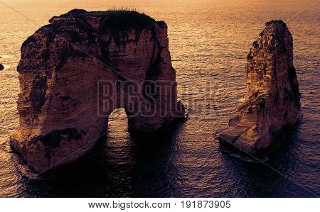 two rocks in the sea at sunset - Pigeons Rock / Sabah Nassar's Rock / Raouche in Beirut, Lebanon