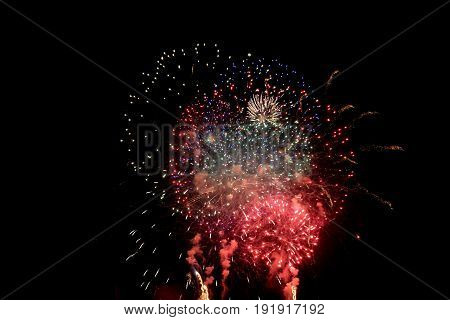 Big colorful fireworks with many red  in the black night sky