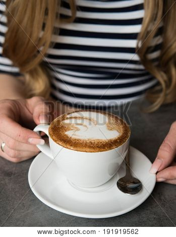 Beautiful girl with coffee in the coffeshop