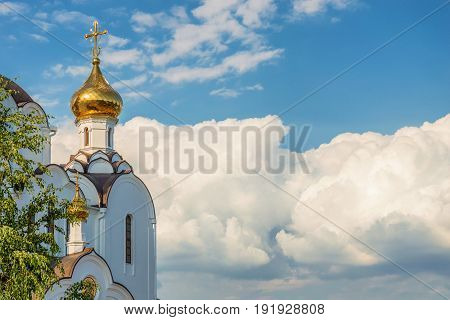 Part of Russian Orthodox church with golden domes on sunny day