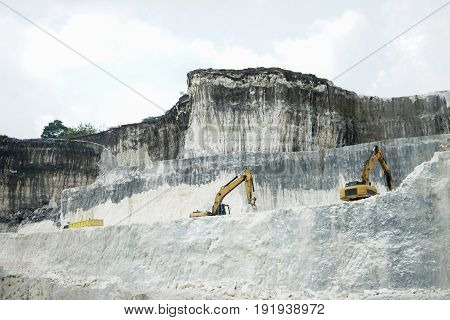 The exploitation of limestone hills forming a unique architectural in Jeddih or Jaddih Hill Madura Island, Indonesia