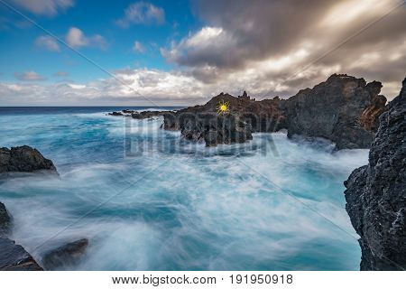 Wide angle long exposure of Biscoitos with volcanic rocks in Terceira Island, Portugal