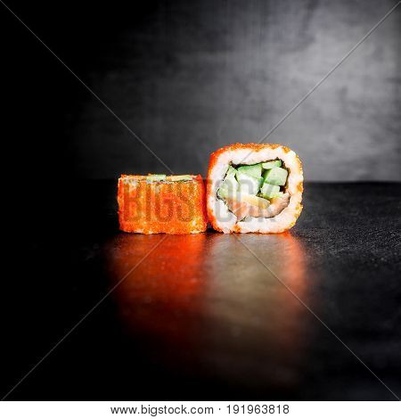 Sushi rolls on gark background. Japanese food