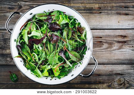 Mix Of Fresh Leaves With Arugula, Lettuce, Beets. Ingredients For Salad On A Wooden Background.