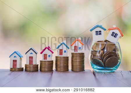 Mini House On Stack Of Coins,money And House,  Mortgage, Savings Money For Buy House And Loan To Bus