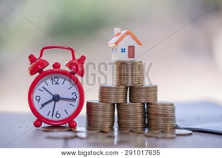 Mini House On Stack Of Coins,money And House,  Mortgage, Savings Money For Buy House And Loan To Bus