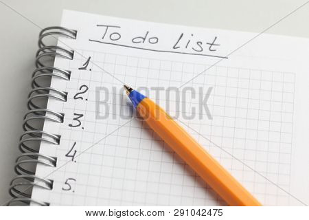 To Do List On White Note Pad With Ballpoint Pen. Close-up.
