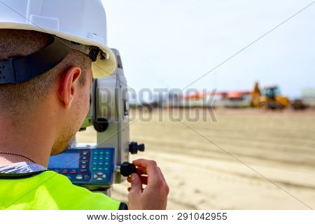 Surveyor Engineer Is Measuring Level On Construction Site. Surveyors Ensure Precise Measurements Bef