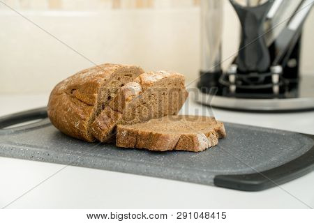Sliced Bread And Set Of Six Knives On A Modern Kitchen