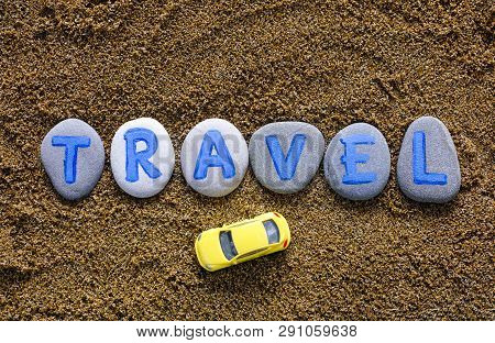 Word Travel Spell Out From Stones With Letters And Yellow Car On Sea Sand. Letters Drawn By Me