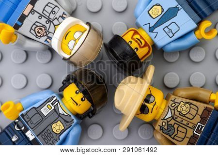 Tambov, Russian Federation - May 12, 2016 Four Lego Policemen Minifigures On Lego Gray Baseplate Bac