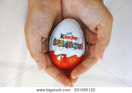 Paphos, Cyprus - November 21, 2016 Child Hands With Kinder Surprise Egg. Word Surprise Written In Ge