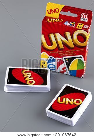 Tambov, Russian Federation - August 15, 2013 Two Decks Of Uno Game Cards And Uno Game Box On Gray Ba