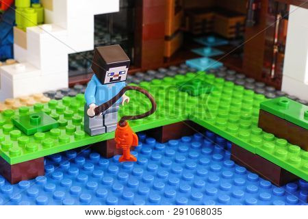 Tambov, Russian Federation - June 25, 2017 Lego Minecraft. Steve Minifigure Is Fishing Near Waterfal