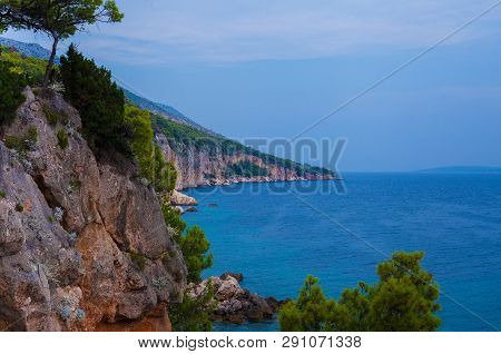 Amazing Tranquille Sea Landscape With Rocks And Green Trees