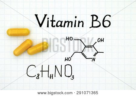 Chemical Formula Of Vitamin B6 With Yellow Pills. Close-up.