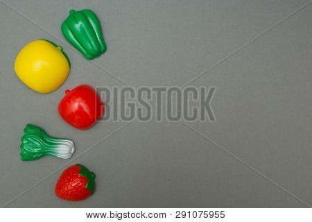 Artificial Fruits And Vegetables On A Gray Background