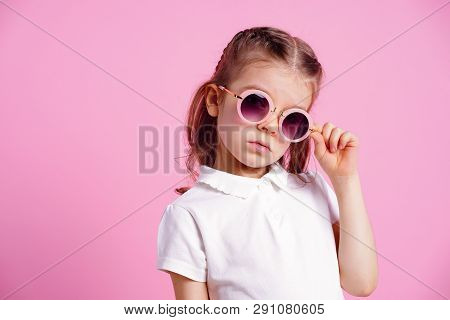 Portrait Of Beautiful Smiling Cute Model In Trendy Round Sunglasses. Casual 7 Y.o. Girl Posing Isola