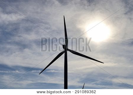 View On Alternative Energy Windmills In A Windpark In Northern Germany In Front Of A Blue Sky