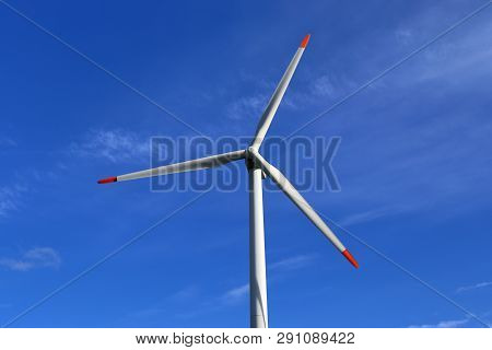 View On Alternative Energy Windmills In A Windpark In Northern Germany In Front Of A Blue Sky
