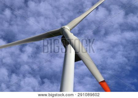 View On Alternative Energy Windmills In A Windpark In Northern Germany In Front Of A Blue Sky