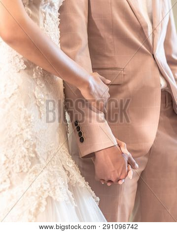 Married Couple Bride And Groom Holding Hands In Wedding Ceremony For Marriage Concept