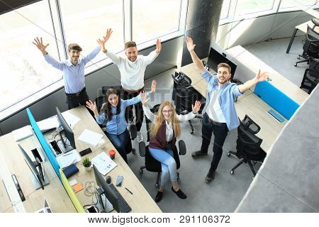 Top View Of Young Modern Colleagues In Smart Casual Wear Working Together While Spending Time In The